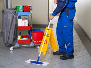 Janitor-With-Broom-Cleaning-Of-113497175.jpg